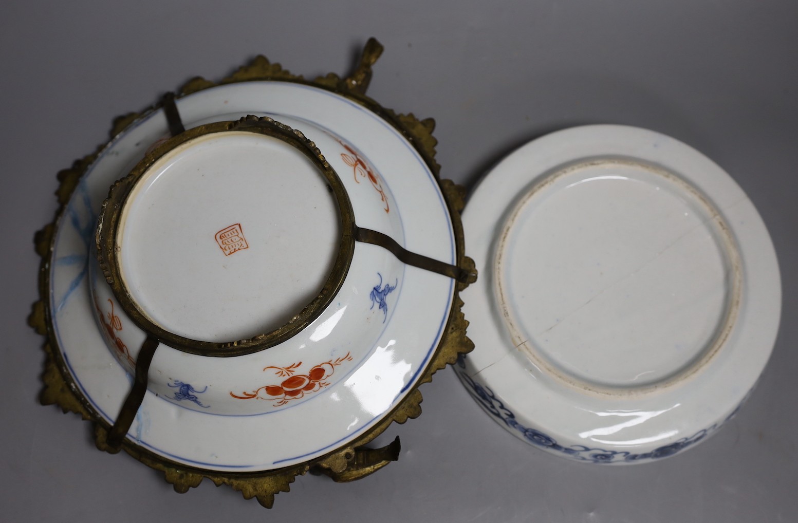 A Chinese clobbered dish with bronze mount, a Chinese blue-and-white Buddhist lion dish and a blue and white landscape bowl, 18th century and later